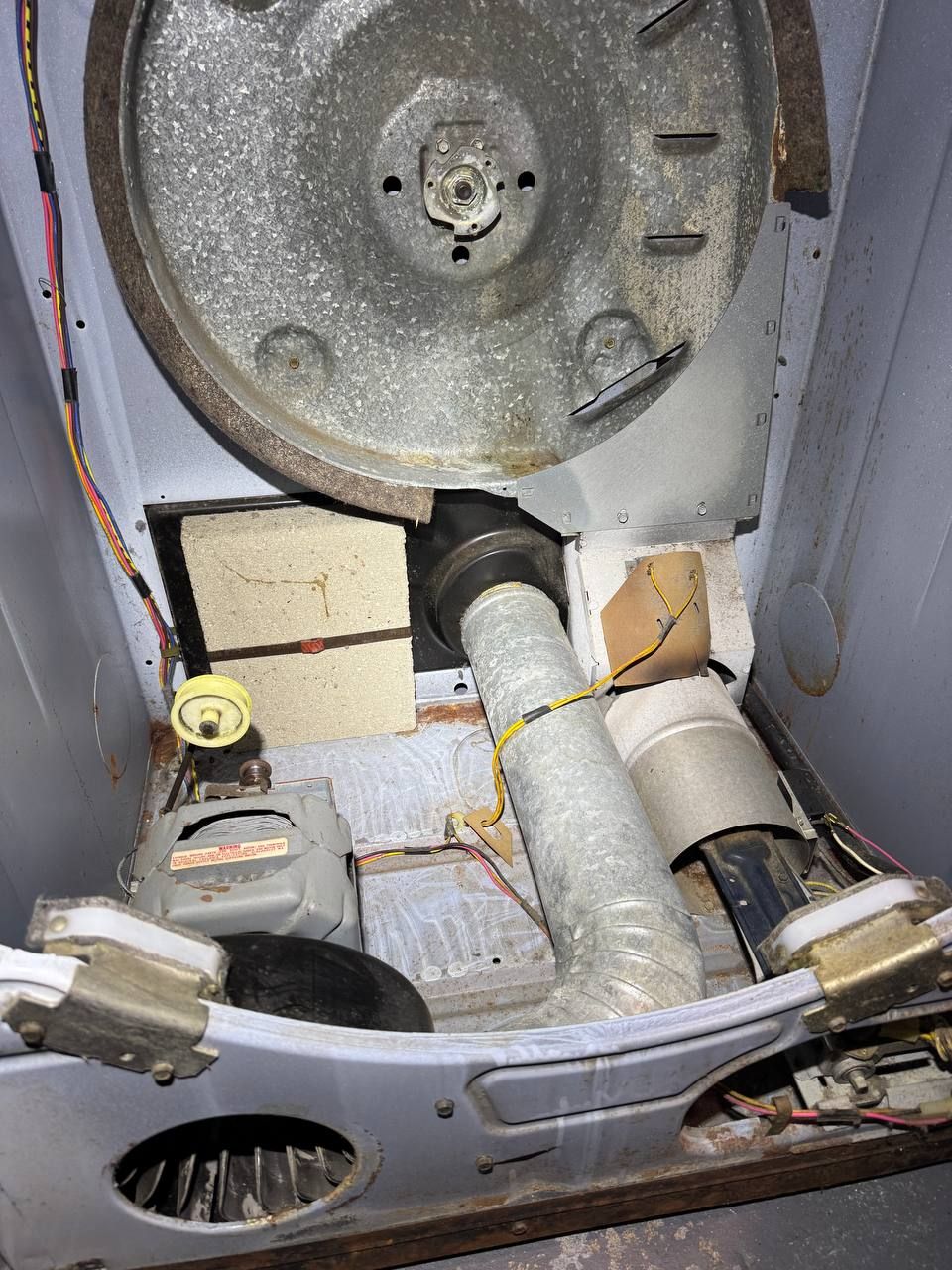Same dryer cabinet after cleaning, blower wheel and internal duct clear of lint